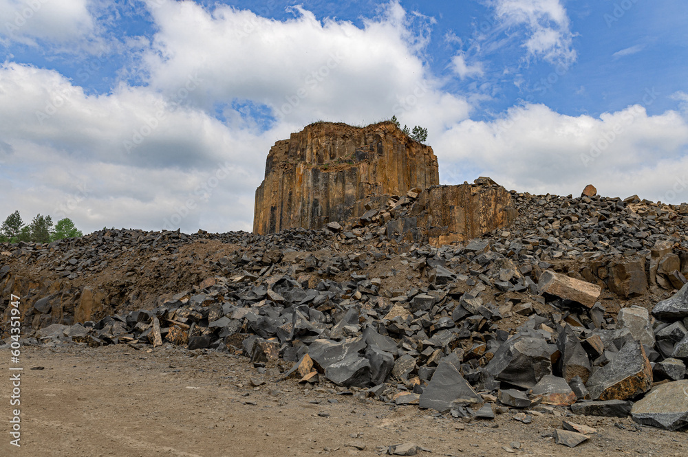 Geologic basalt rock formation. Basalt quarry. Columnar basalt quarry in summer.