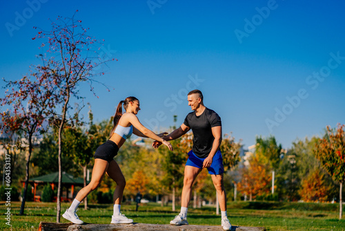 Beautiful fit couple having fun in the park while exercising