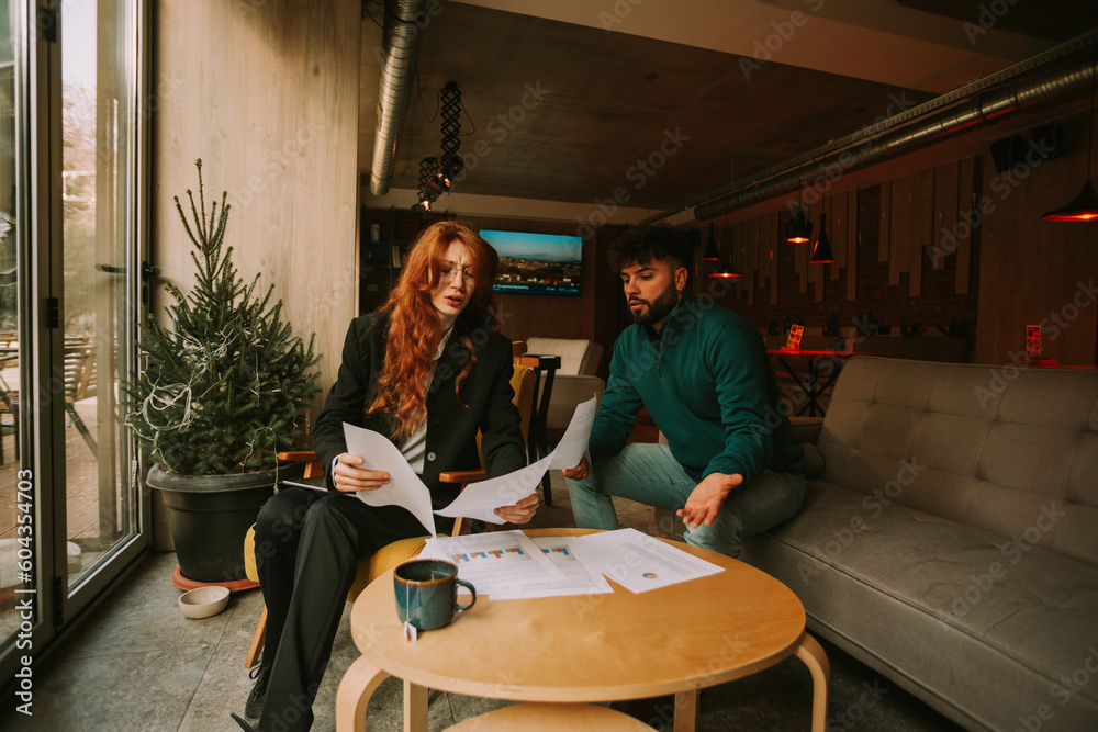 Confused young business people cannot figure it out what is going on with their company sales. Low business profit Confused young business people cannot figure it out what is going on with their company sales. Low business profit