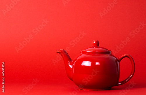 Red Teapot On A Red Background