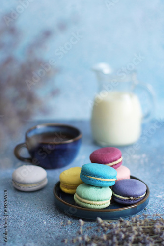 Fresh colorful macaroons for breakfast on blue background	