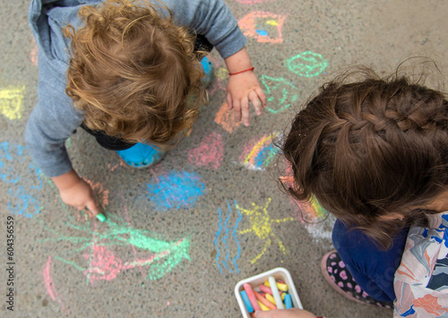 Children draw with chalk on the pavement. Selective focus.