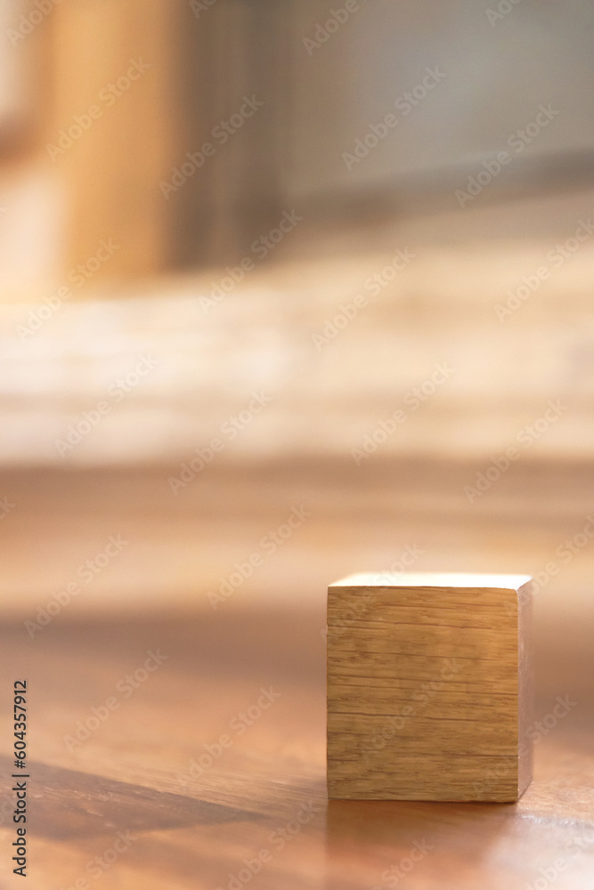 Blank wooden cube block on wooden table with shades of light through the window. Copy space for your text or number. Blank wooden cube block on wooden table with shades of light through the window. Copy space for your text or number.