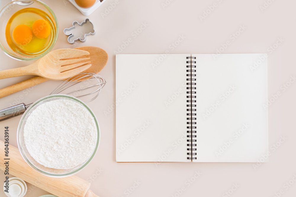 Blank notepad on a white background. Culinary cooking baking concept, place for a recipe. Top view.