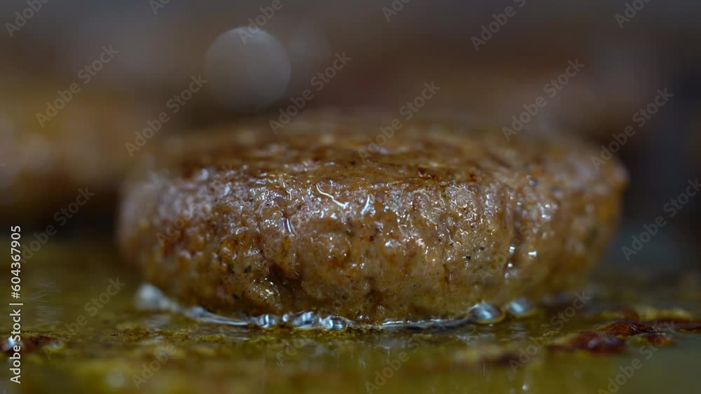 Barbecue cutlets look very tasty cooked for a hamburger on a hot open fire on the grill turns over with a spatula after each turn the fire flares up and creates a beautiful suitable for any restaurant Barbecue cutlets look very tasty cooked for a hamburger on a hot open fire on the grill turns over with a spatula after each turn the fire flares up and creates a beautiful suitable for any restaurant