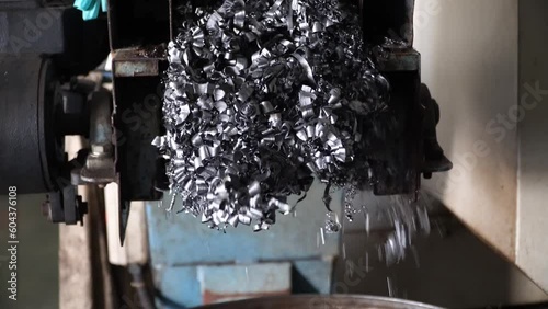 Steel Scrap Moving Scrap Conveyor Lathe Machine,Steel scrap materials recycling. Aluminum chip waste after machining metal parts on a cnc lathe. Closeup twisted spiral steel shavings. Small roughness 