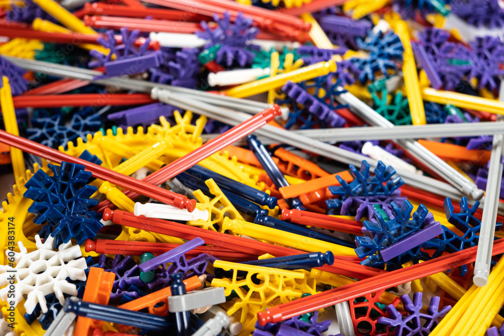 Children's constructor of gears cogwheel and sticks in the children's room. Toys for the development of logic and thinking