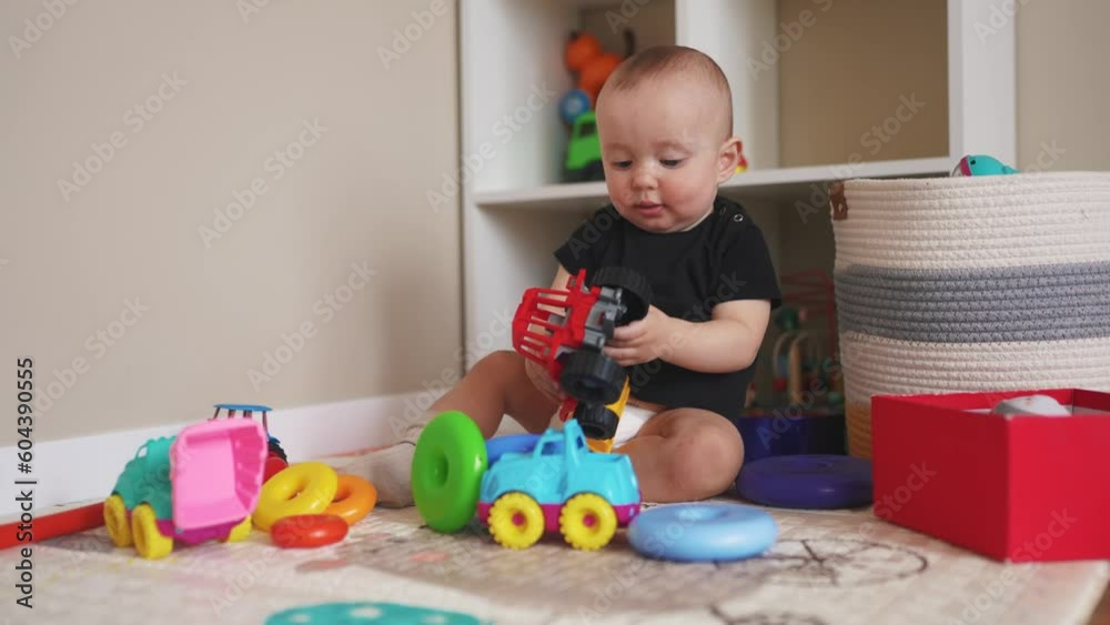baby boy play in kindergarten. baby child play toys cubes and cars on the table in kindergarten. happy family preschool education indoor concept. nursery baby lifestyle toddler play toy home baby boy play in kindergarten. baby child play toys cubes and cars on the table in kindergarten. happy family preschool education indoor concept. nursery baby lifestyle toddler play toy home