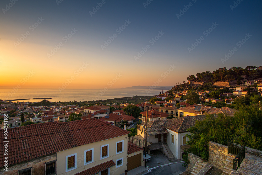 Fototapeta premium Beautiful sunset view by the historical castle of Kyparissia coastal town at sunset. Located in northwestern Messenia, Peloponnese, Greece, Europe.