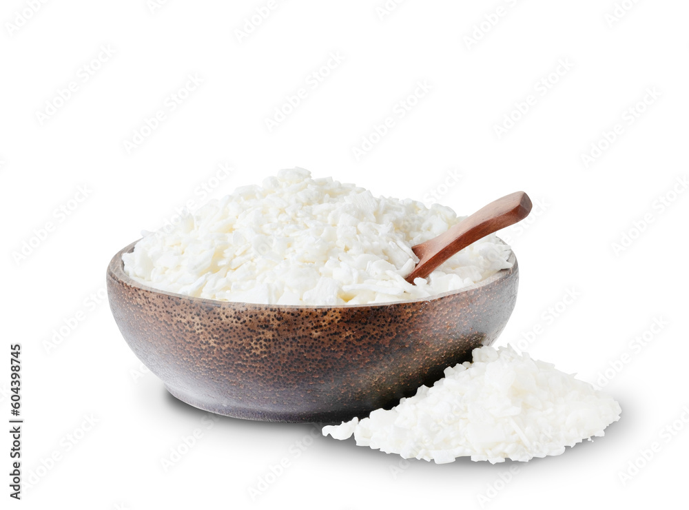 Organic white soy wax flakes for candles in coconut bowl isolated on white background