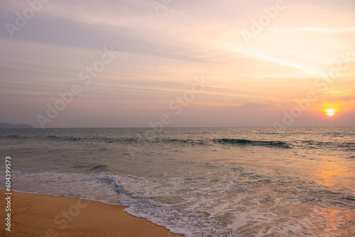 Very nice sunset over the sea at Mai Khao Beach on the island of Phuket in Thailand.