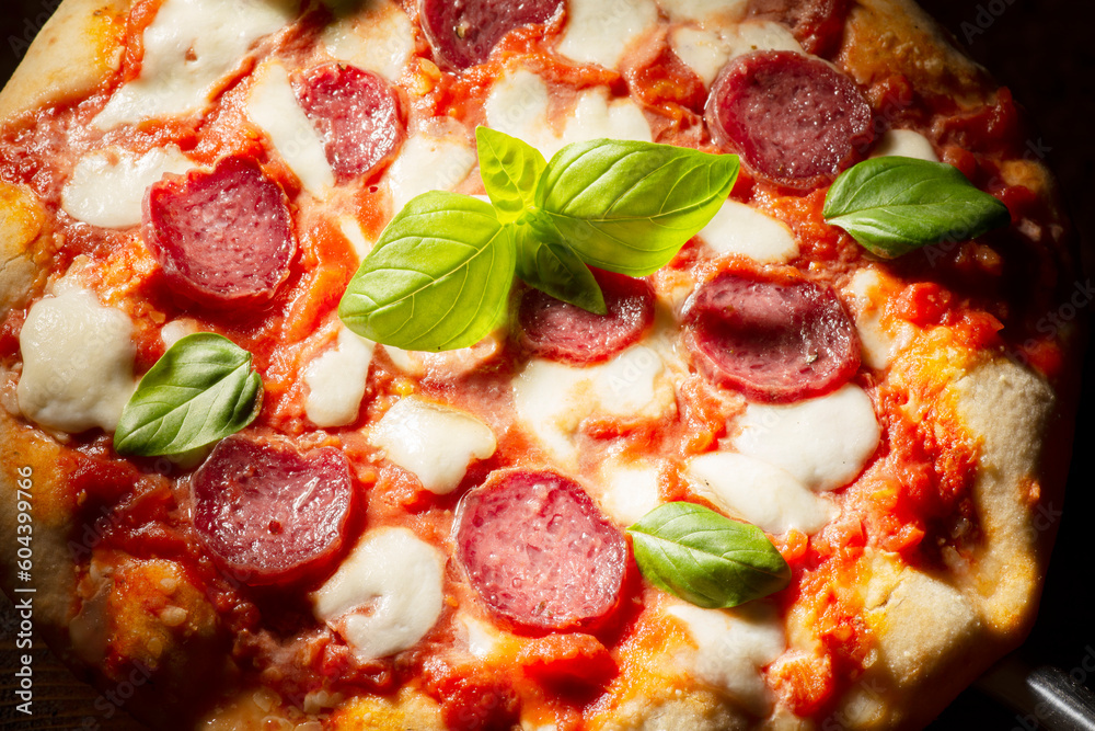 pizza with salami and tomatoes and mozzarella pizza with salami and tomatoes and mozzarella