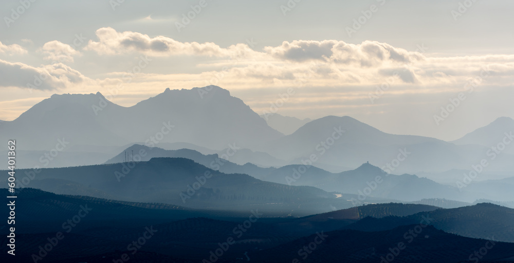 mountains in the fog at sunset 