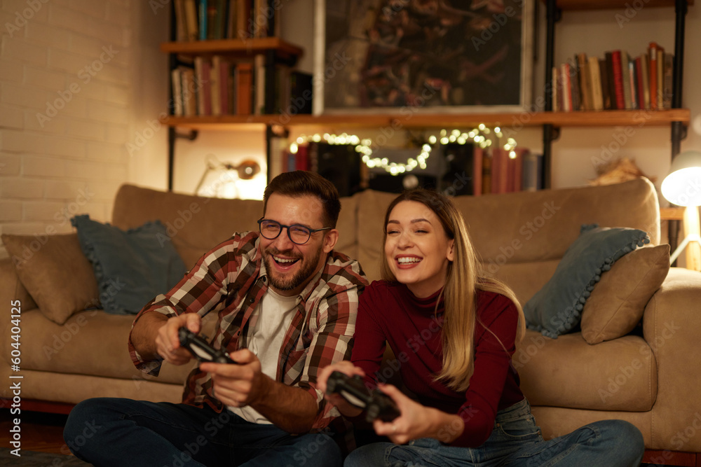 Young couple having fun at home playing video games Young couple having fun at home playing video games