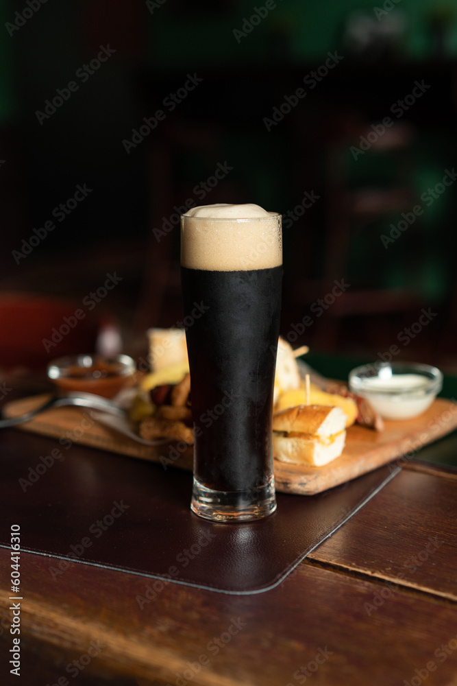 Still life of Glass of stout beer on pub table