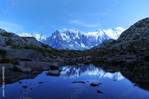 Moonlight landscape of Mont Blanc Massif reflecting in an alpine lake, French Alps