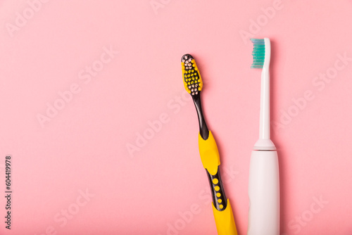 electric toothbrush  bamboo and handmade toothbrushes on a pink background with copy space. Flat lay. Oral hygiene. Oral care kit. Dentist concept. Place for text. Place to copy.