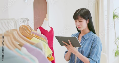 asia clerk checking clothes stock photo