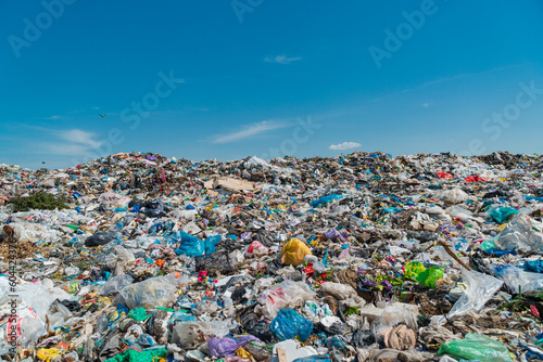 Open-air landfill. Large garbage pile on sky background. Household waste. Pollution concept © Jenya Smyk