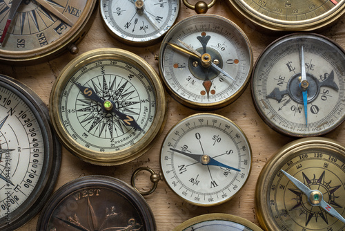 Collection, set of old compasses on the table. Travel, geography, navigation, tourism, histoory and exploration concept background. Old compass background.