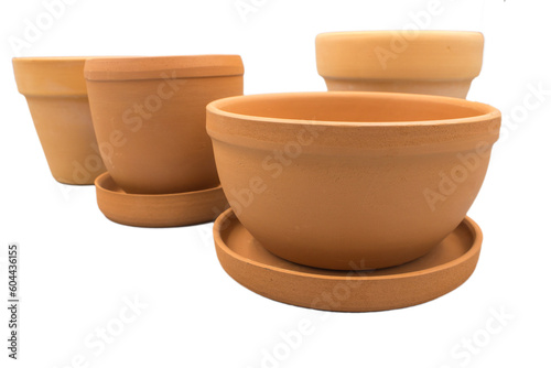 Empty clay flower pots of different shapes isolated on a white background