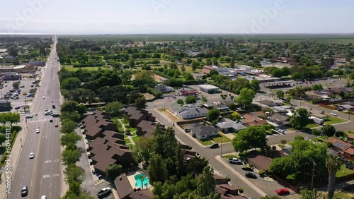 2023 - Excellent aerial view moving from a major road to housing in Corcoran, California. photo