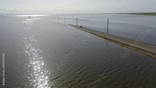 2023 - Excellent aerial view moving over a sunlit flooded road in Corcoran, California. photo