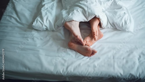Family couple in bed making love at house, romance woman and man legs togetherness in bedroom. Relationship and intimate of romantic lovers, sexual activity in happy family. naked foot from mattress