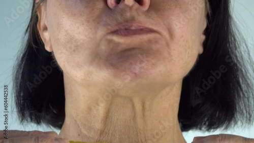 mouth of woman eating an ear of corn closeup