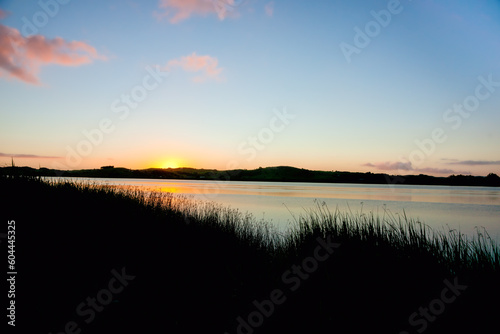 Sunrise over calm Wairoa river photo