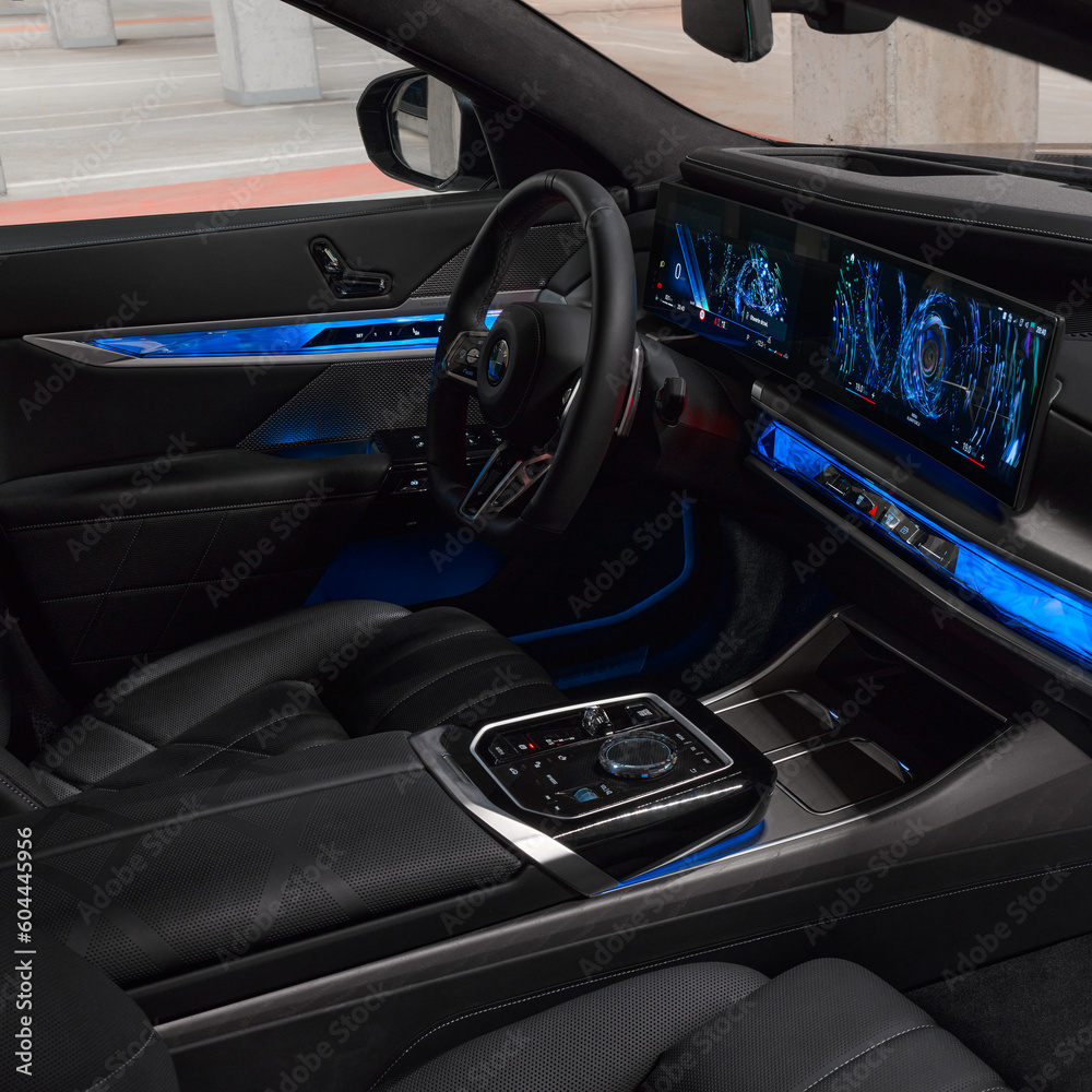 Blue illuminated interior and dashboard of a BMW 7 series, viewed ...