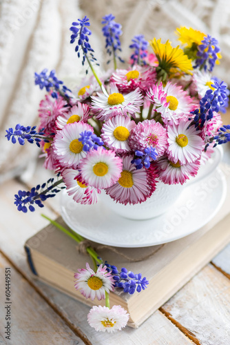 Bouquet of daisy with pink flowers in a ceramic white mug, wooden background. Romantic still life, summer or spring inspiration, cozy home decor. Greeting card for birthday, anniversary, Mother's Day