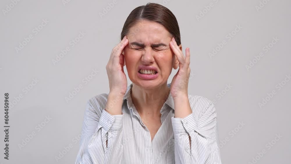Middle-aged woman suffer from headache over grey background. Middle-aged woman suffer from headache over grey background.