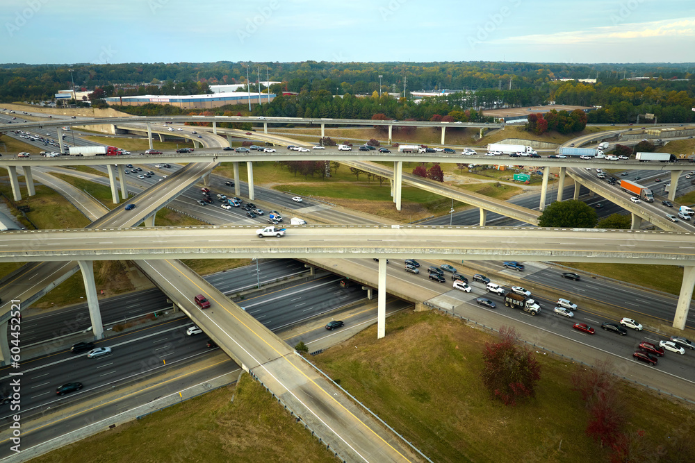 Aerial view of american freeway intersection with fast moving cars and trucks. USA transportation infrastructure concept