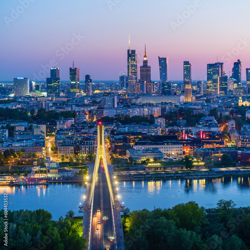 Warsaw city center, Vistula river and Swietokrzyski bridge at dusk, moody aerial landscape