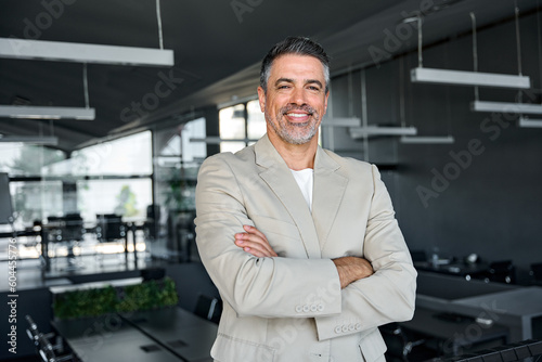 Wallpaper Mural Smiling confident middle aged business man, mature older professional successful company ceo corporate leader wearing beige suit standing in modern office arms crossed looking at camera, portrait. Torontodigital.ca