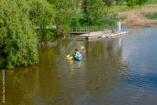 People At the Kayak Launch Dock On The River In Spring photo