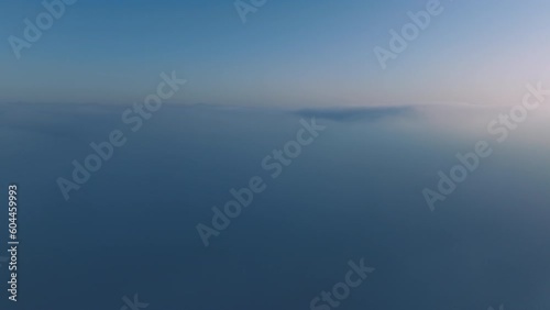 Wallpaper Mural Beautiful ocean of blue clouds at sunrise with pink sky. Drone flying fast above endless sea of clouds until horizon. Amazing nature landscape, 4K drone in sky. Drone raising above thick foggy clouds Torontodigital.ca