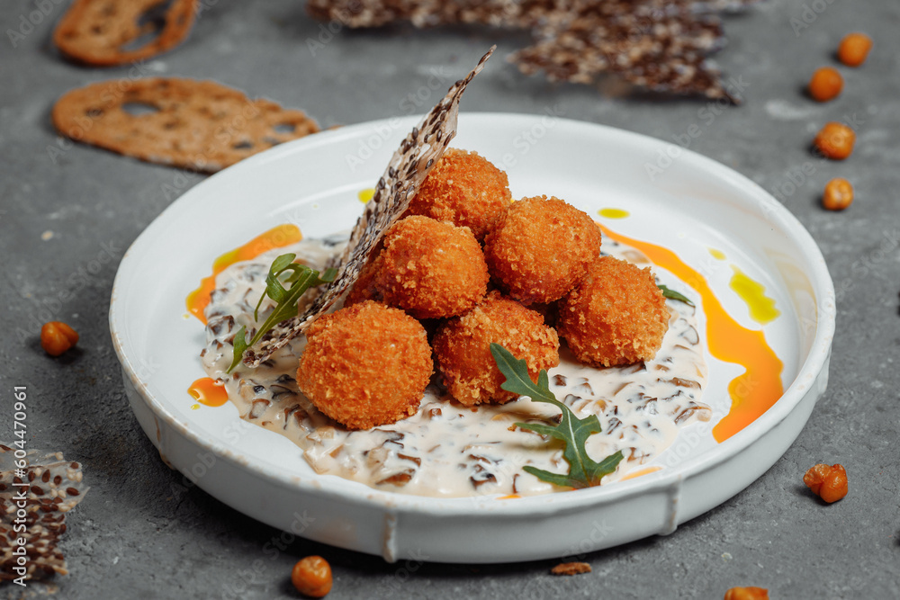 Potato croquettes - mashed potatoes balls breaded and deep fried, served with different sauce. Potato croquettes - mashed potatoes balls breaded and deep fried, served with different sauce.