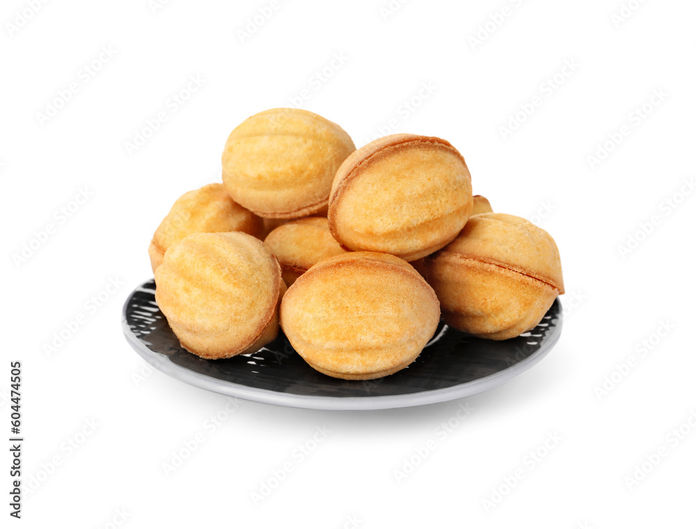 Plate of delicious nut shaped cookies with condensed milk on white background