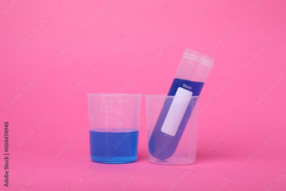 Beakers with test tube and liquid on bright pink background. Kids chemical experiment set Beakers with test tube and liquid on bright pink background. Kids chemical experiment set