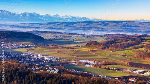 Beautiful panorama landscape of Swiss Alps mountain from Uetliberg,Switzerland.Top summit of Zurich in winter season.Tourist destination for travel.Sunrise with blue sky and snow cap mountain.
