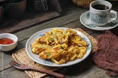 Vegetable Fritters. Malaysian called Cucur Sayur or Cekodok Sayur. Indonesian called Bakwan Sayur. Served with chili sauce. A popular snack in  Southeast Asia. photo