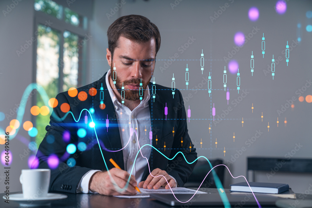 Calm businessman in formal wear signing contract at office workplace with coffee cup, laptop and notebook. Concept of successful deal, agreement, partnership, documents. Forex charts business icons.