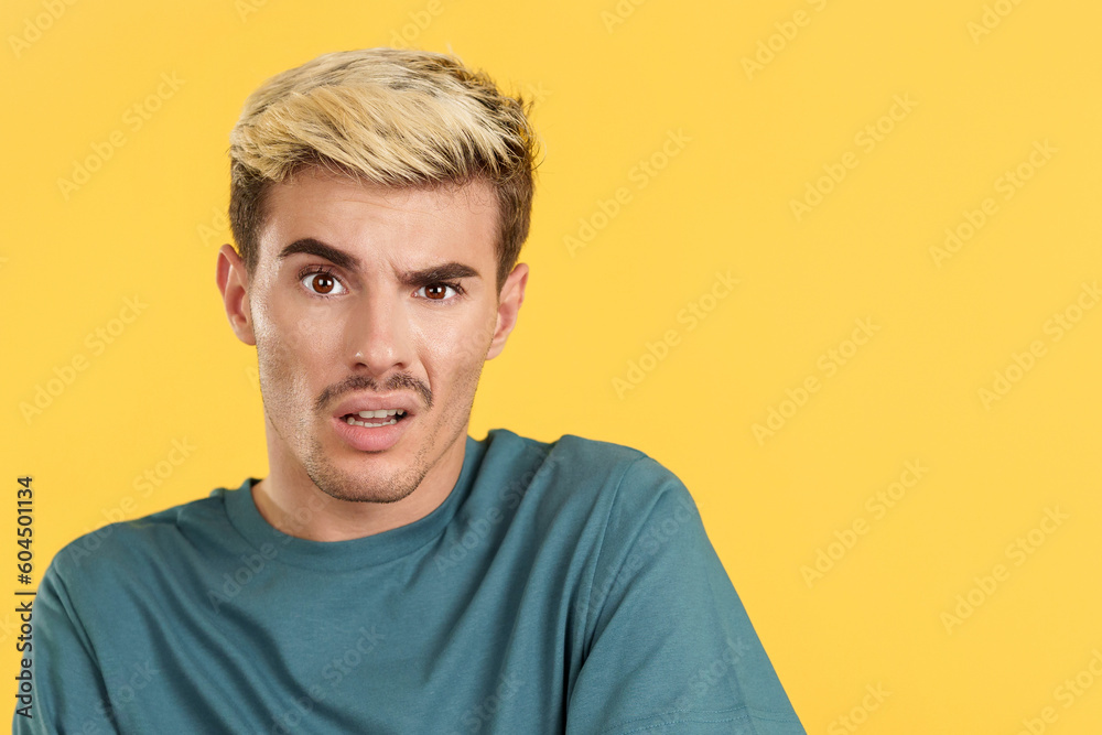 Blank-faced gay man stares at the camera Blank-faced gay man stares at the camera