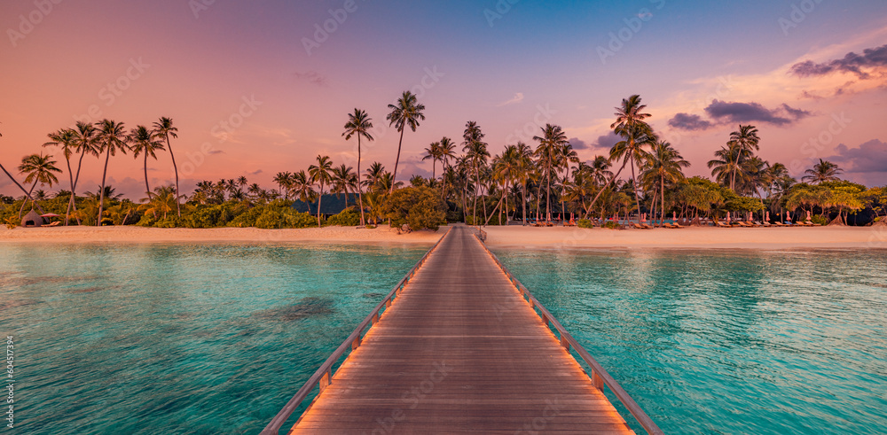 Amazing sunset panorama at Maldives. Luxury resort bridge pier with soft led lights under colorful sky clouds. Beautiful palm trees. Tranquil panoramic beach coast. Best vacation travel landscape - obrazy, fototapety, plakaty 