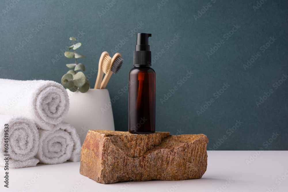 Naklejka premium Cosmetic brown bottle with dispenser in minimal bathroom interior