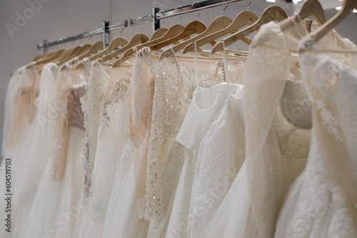 Shallow depth of field (selective focus) details with wedding dresses on display in a shop. © MoiraM