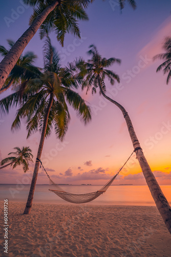 Fototapeta Naklejka Na Ścianę i Meble -  Beautiful silhouette of hammock on palm trees on tropical beach paradise at sunset. Carefree freedom concept, summer nature, exotic shore coast. Tranquil travel landscape. Enjoy life, positive energy