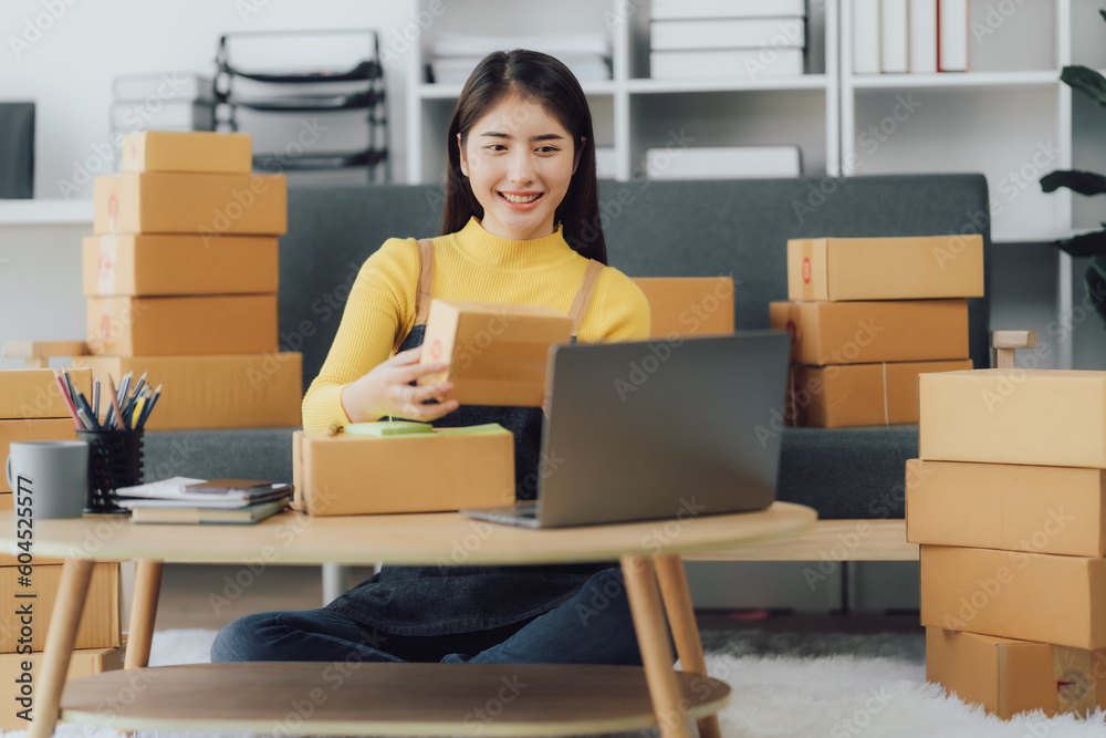 tarting Small business entrepreneur SME freelance,Portrait young woman working at home office, BOX,smartphone,laptop, online, marketing, packaging, delivery, SME, e-commerce concept tarting Small business entrepreneur SME freelance,Portrait young woman working at home office, BOX,smartphone,laptop, online, marketing, packaging, delivery, SME, e-commerce concept